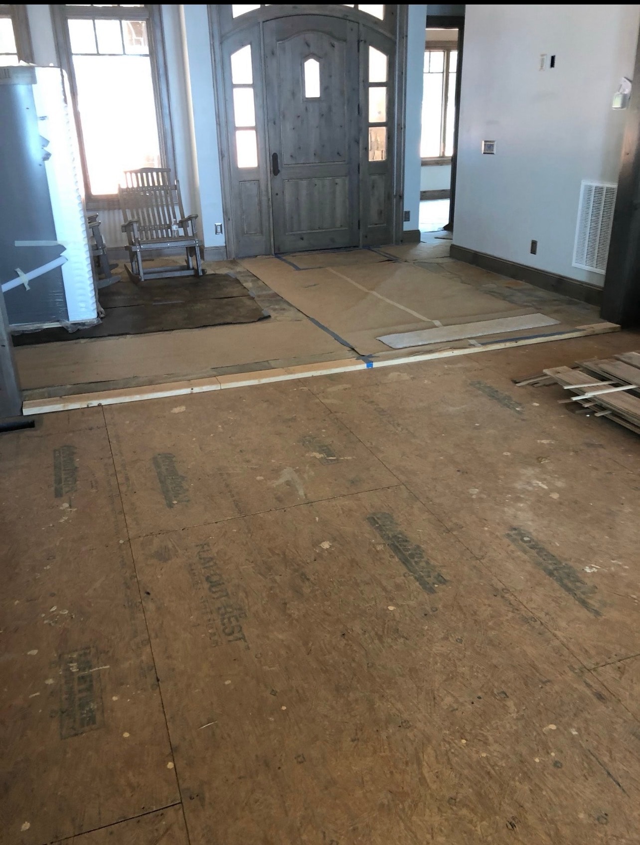 Subfloor inspection – checking Advantech plywood for flatness before hardwood installation