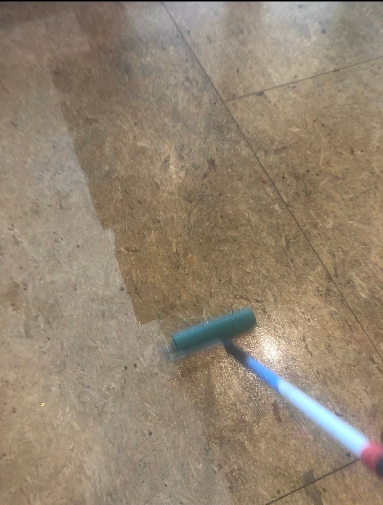Applying Bona R540 moisture barrier primer to subfloor with a roller